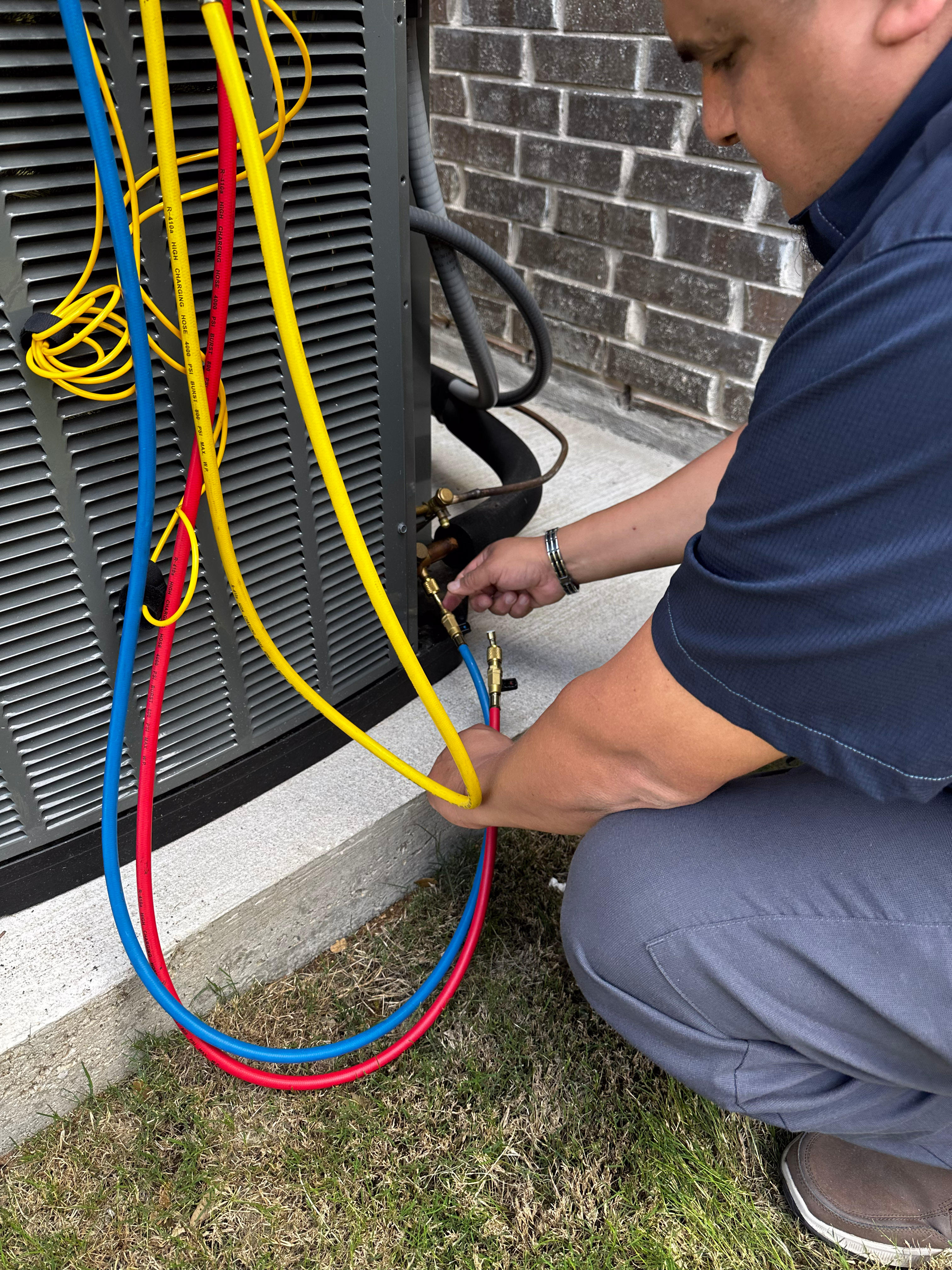 Climate control employee installing new system outside