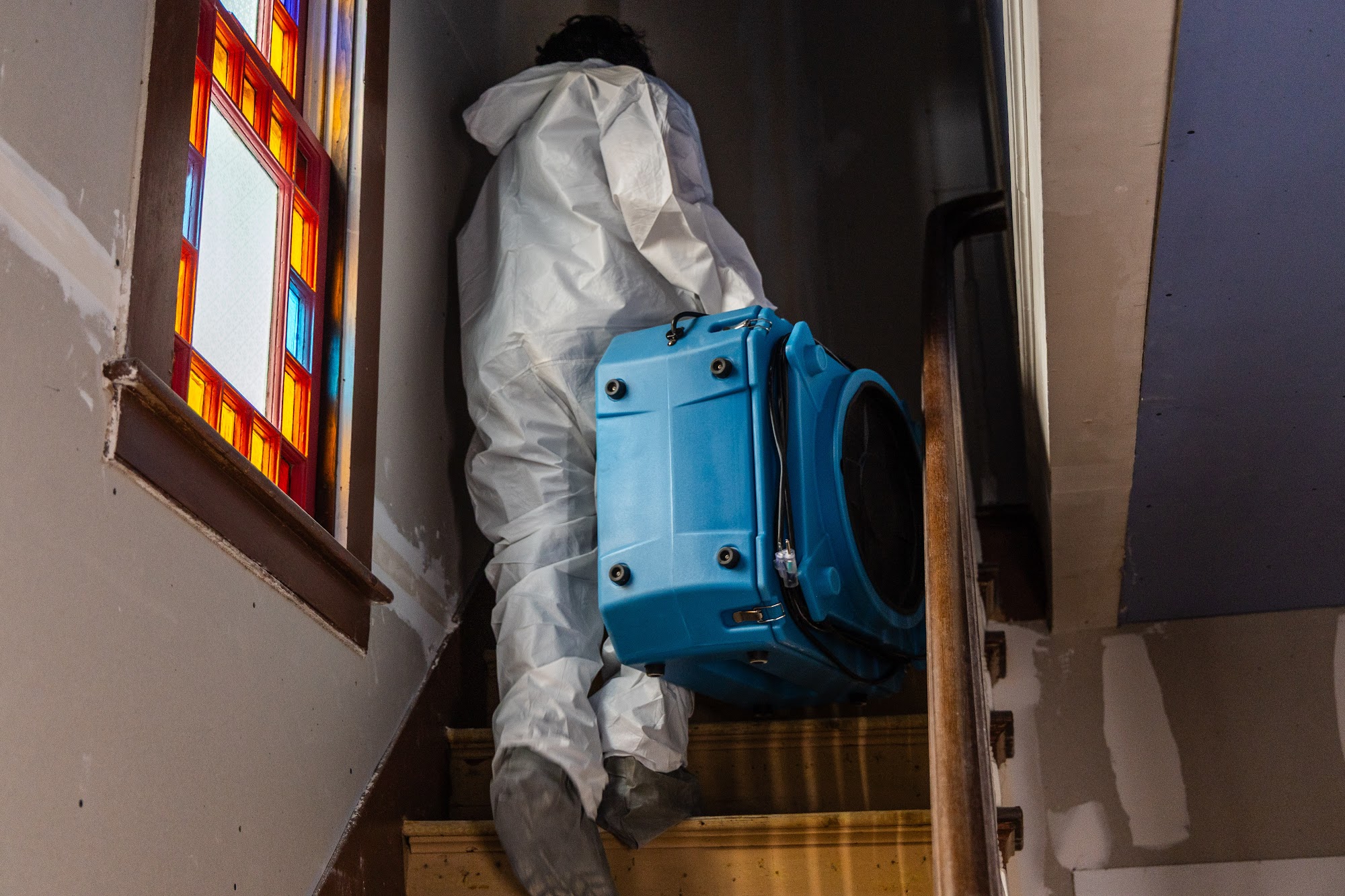 A CT Mold Remediation Specialists technician carries professional remediation equipment on a Connect 