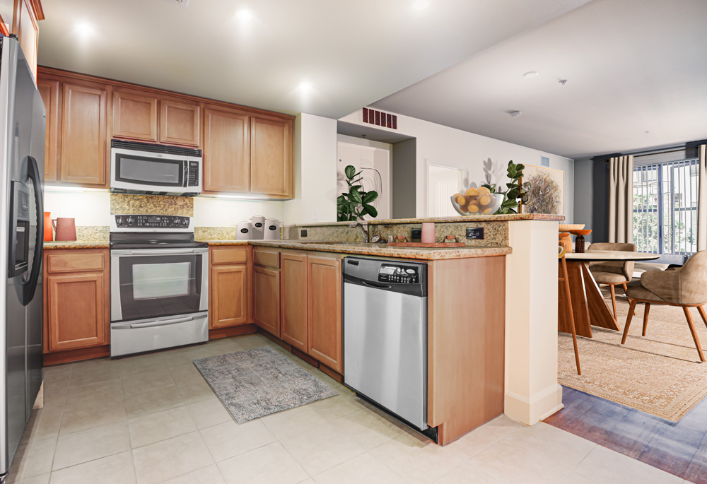 Tiled kitchen with granite counters and oven backsplash, stainless appliances, and maple cabinets.