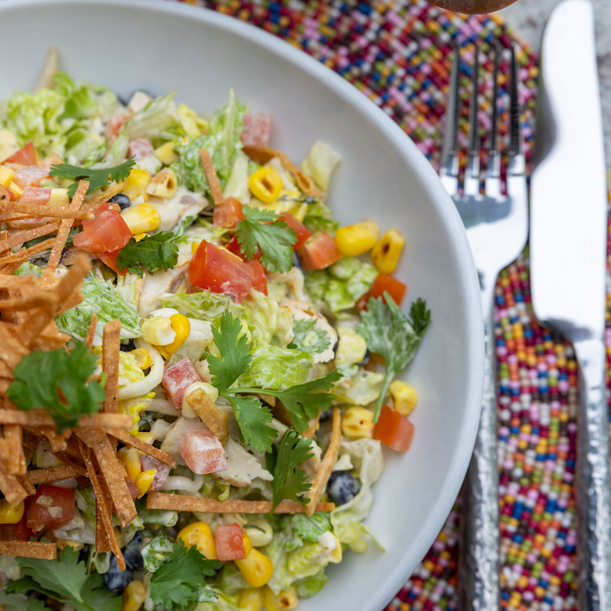 Southwest Grilled Chicken | tomato, corn, avocado, black beans, chipotle ranch, tortilla strips, cilantro