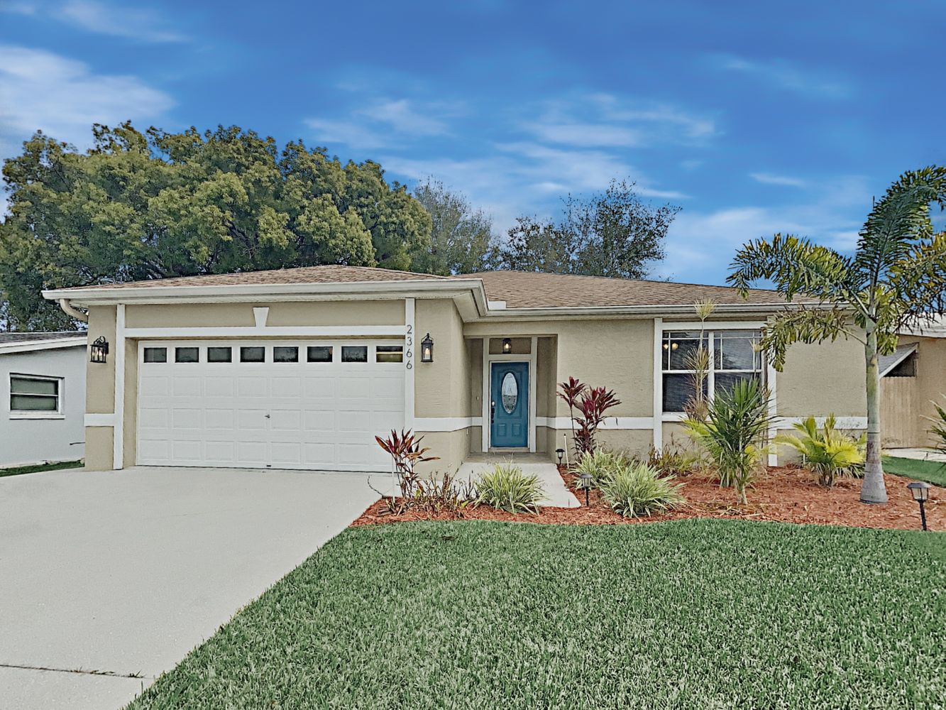 Charming home with a two-car garage and beautiful landscaping at Invitation Homes Tampa.