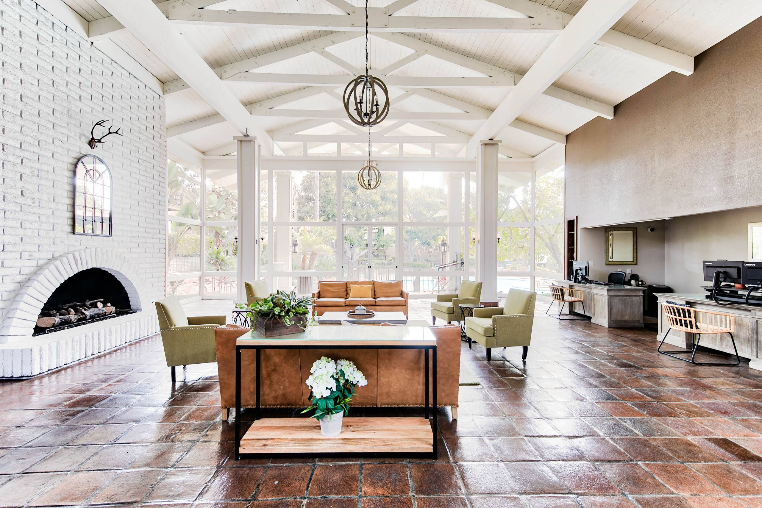 a large living room with a fireplace and a table and chairs