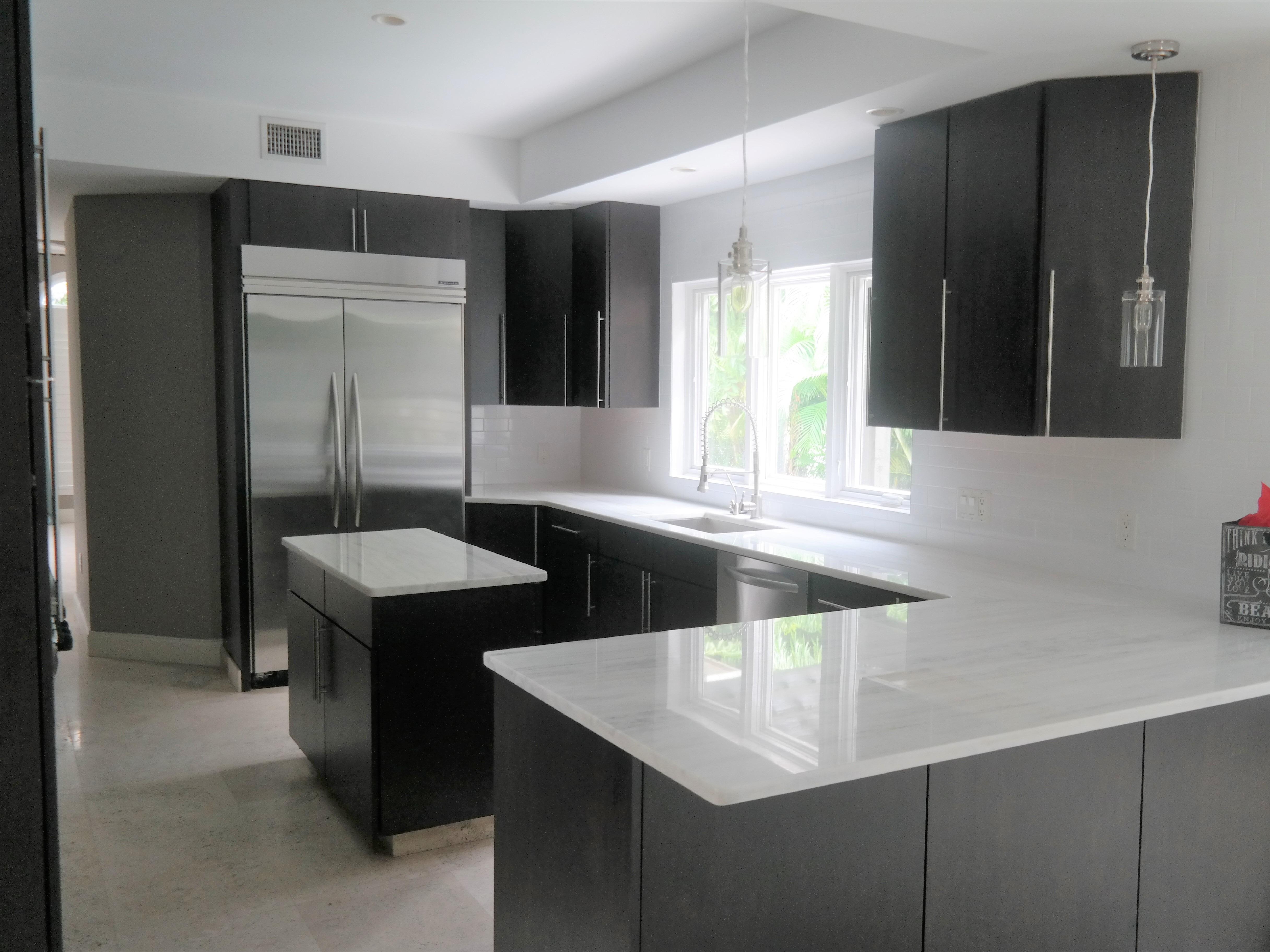 Re-A-Door Kitchen Cabinets Refacing Tampa High-quality modern kitchen cabinet doors in Tampa Florida paired with granite countertops and stainless steel appliances for a sleek, contemporary look.