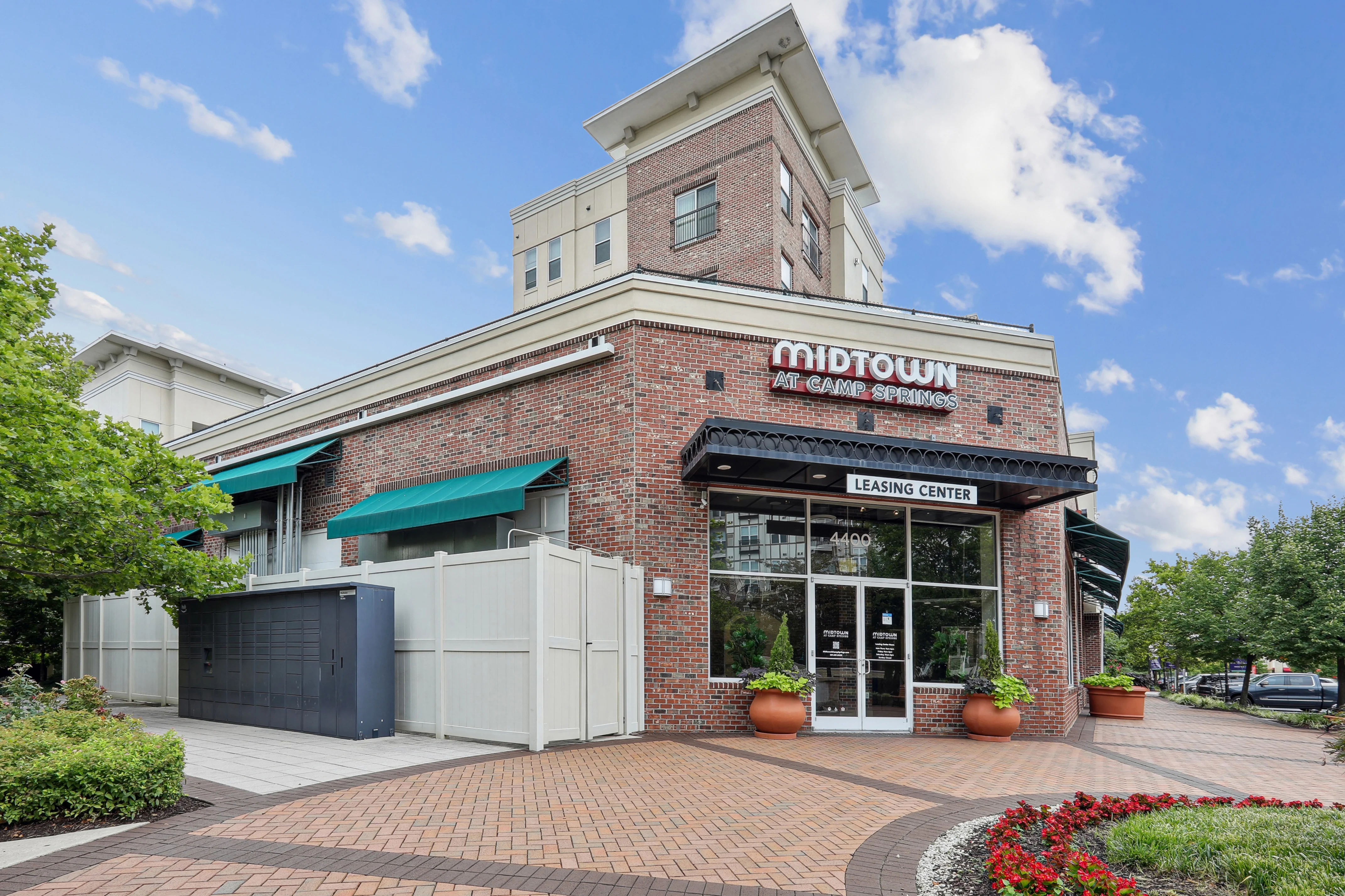 A brick building with a green awning and a sign that says "Midtown" on it.