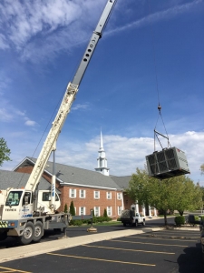 Crane lifting rooftop HVAC unit for BC Ten Air HVACR and Electrical Contractors