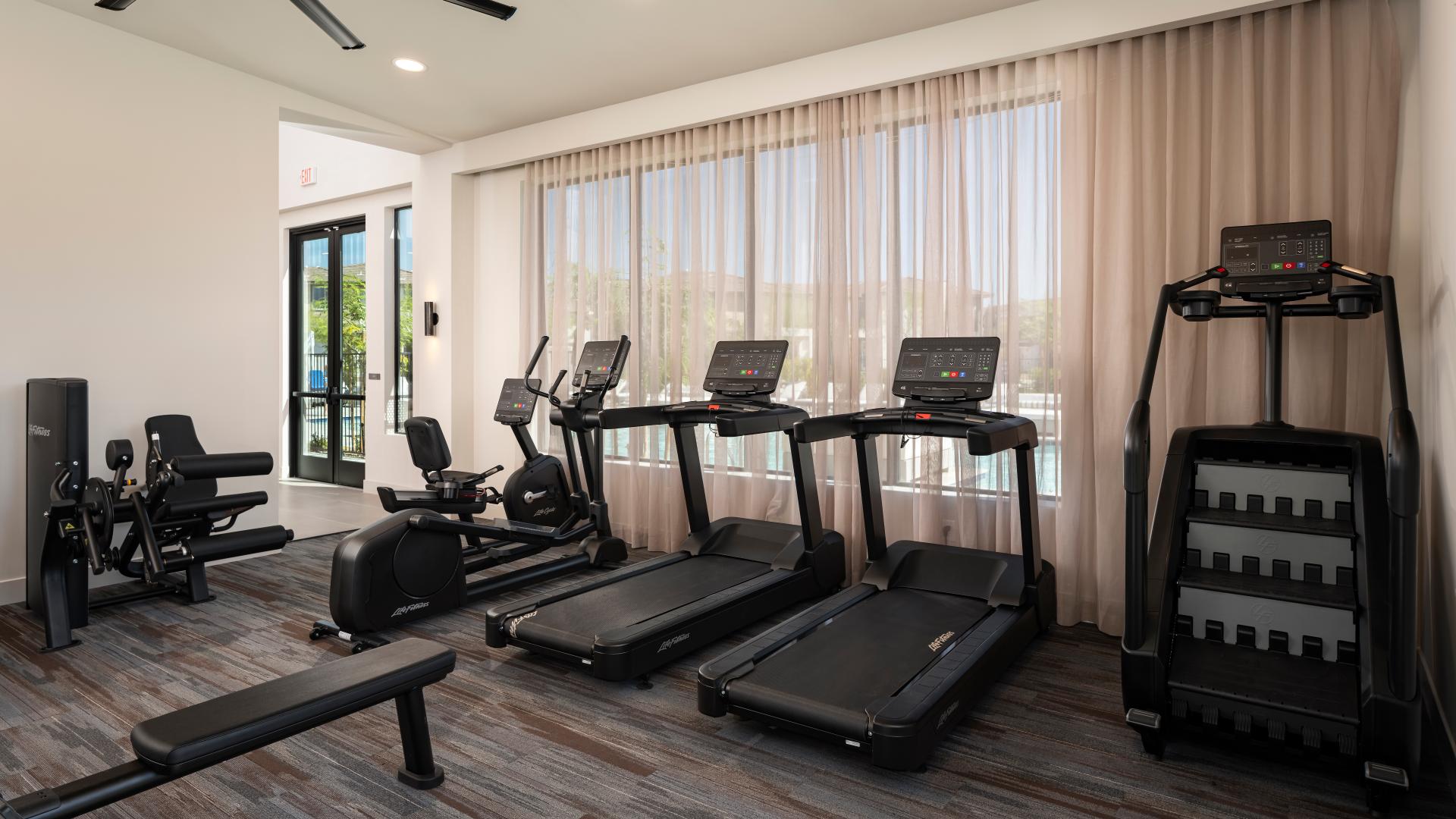 Fitness center with poolside views
