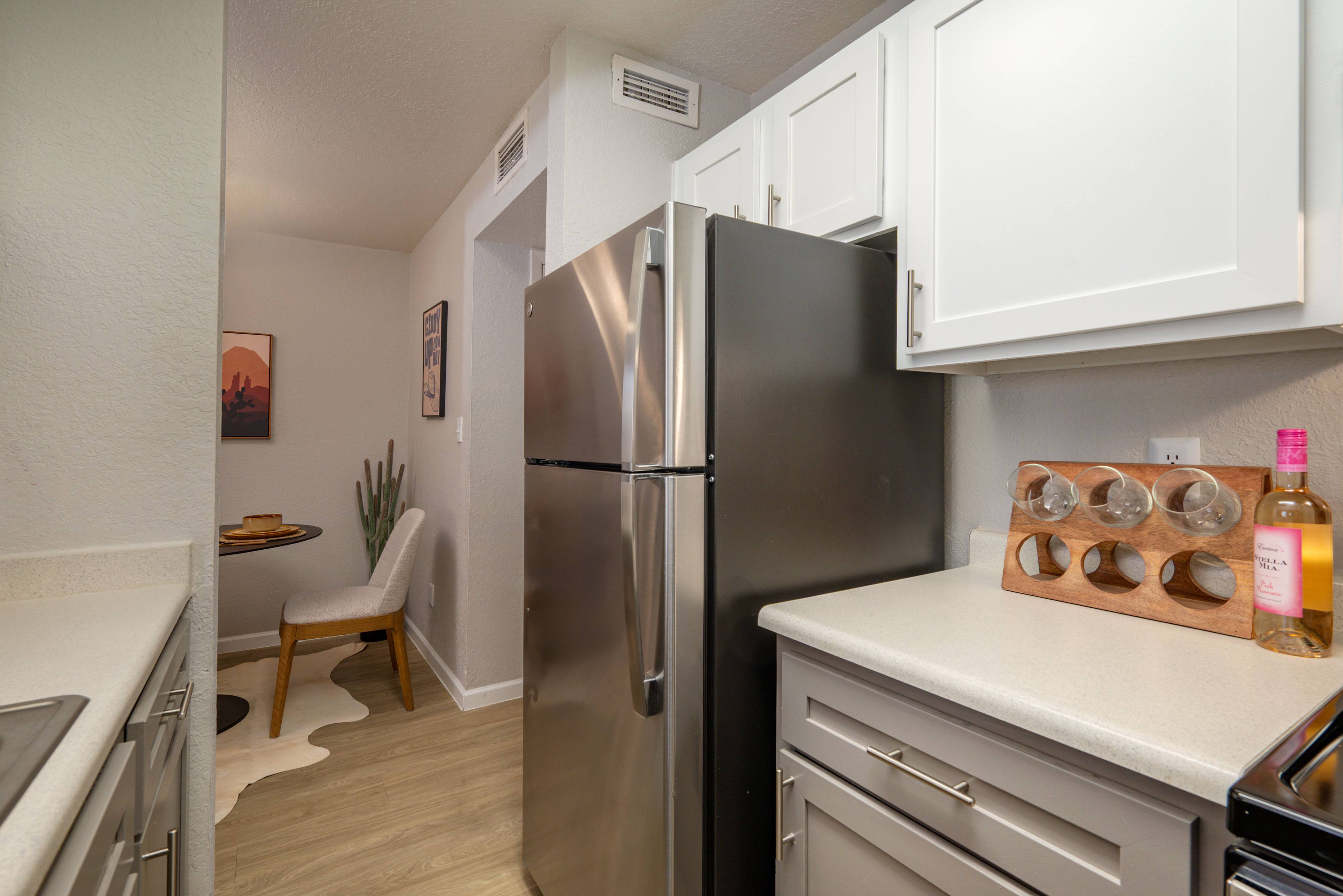 Kitchen with stainless steel refrigerator 