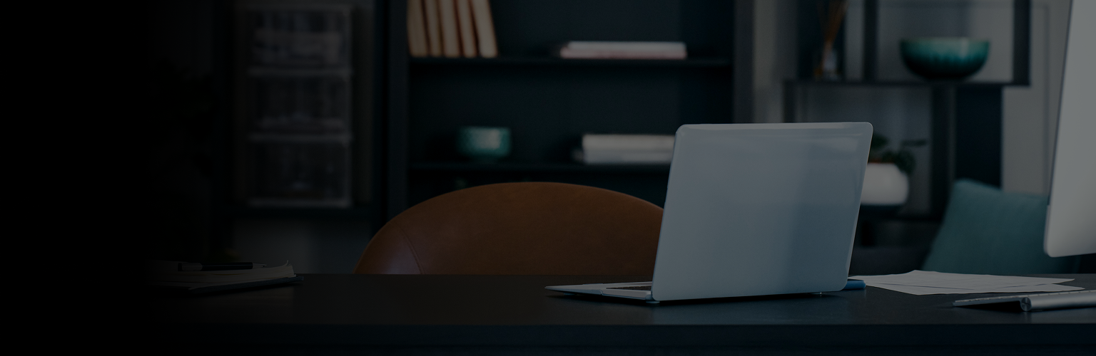 Laptop on a table in an office.