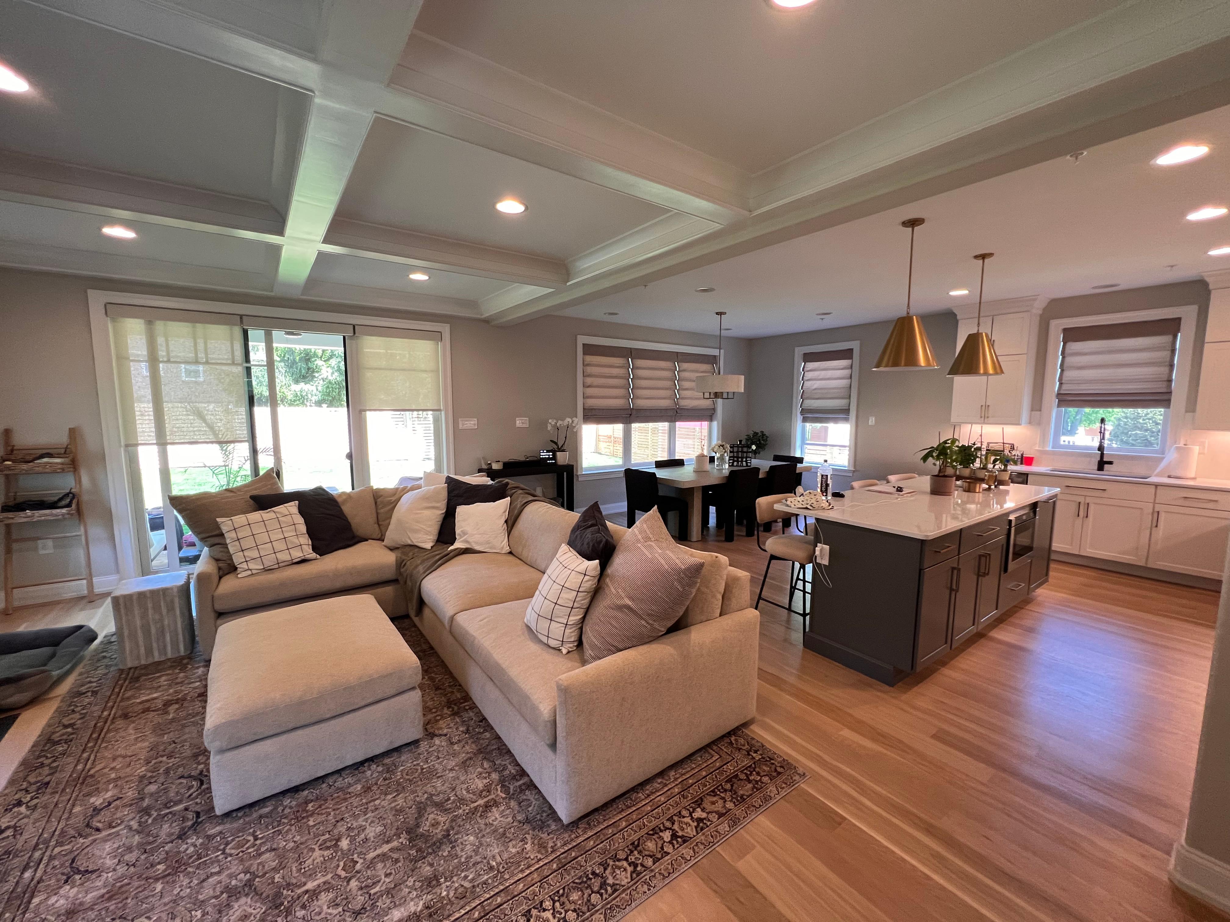 Beautiful Roman shades for the windows and light-filtering roller shades for the sliding door.