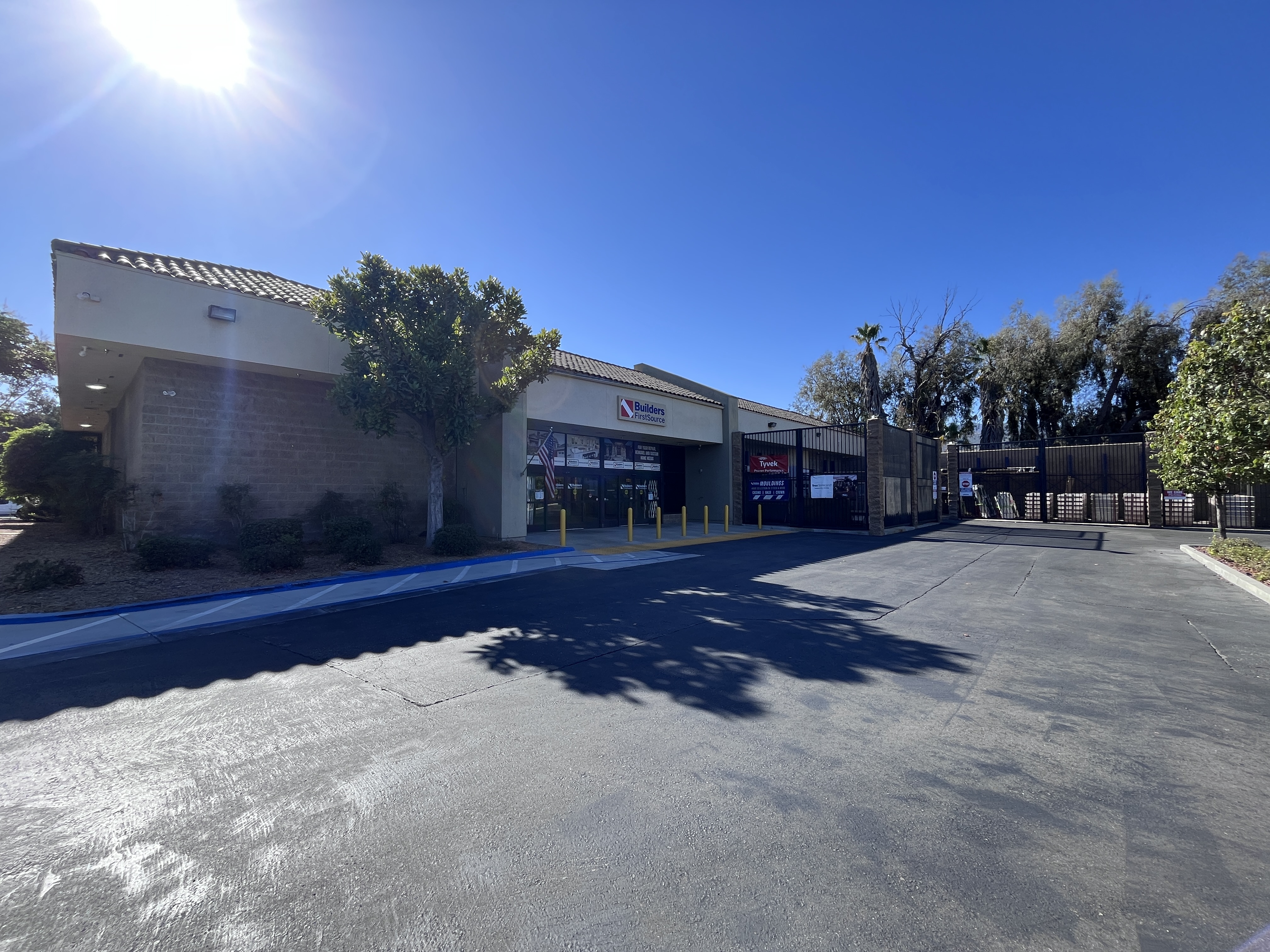Wide exterior view of the Builders FirstSource Thousand Oaks, CA building, showing the entrance, gated yard, and surrounding landscaping.