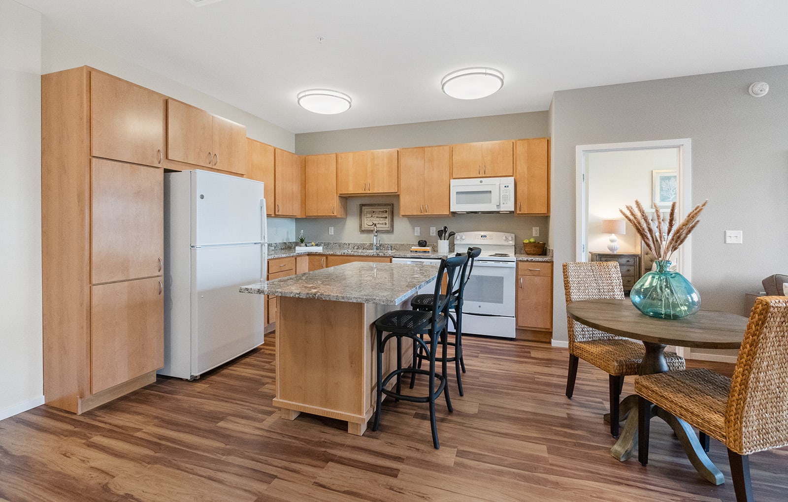 Kitchen with Eat-in Island at Legacy Commons at Signal Hills 55+ Living