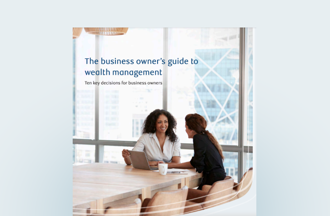 Cover of the business owner's guide featuring two professionals at a board room table.
