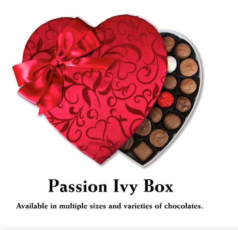 A Valentine's Day-themed table featuring Florence's Exquisite Chocolates in Rexburg, Idaho. The centerpiece is a beautifully packaged heart-shaped box, either containing 24 or 36 pieces of assorted chocolates. The box is adorned with elegant red ribbons and intricate designs, partially open to reveal a variety of chocolates inside. These include Milk Chocolate, Dark Chocolate, Milk and Dark Chocolate, and assortments like Assorted Chocolates or Nuts and Caramels. The table is decorated with romantic touches such as red roses, heart-themed plates, festive napkins, and decorative candy bowls filled with more chocolates and truffles. This cozy and elegant setup highlights Florence's chocolates as the perfect gift for Valentine’s Day.