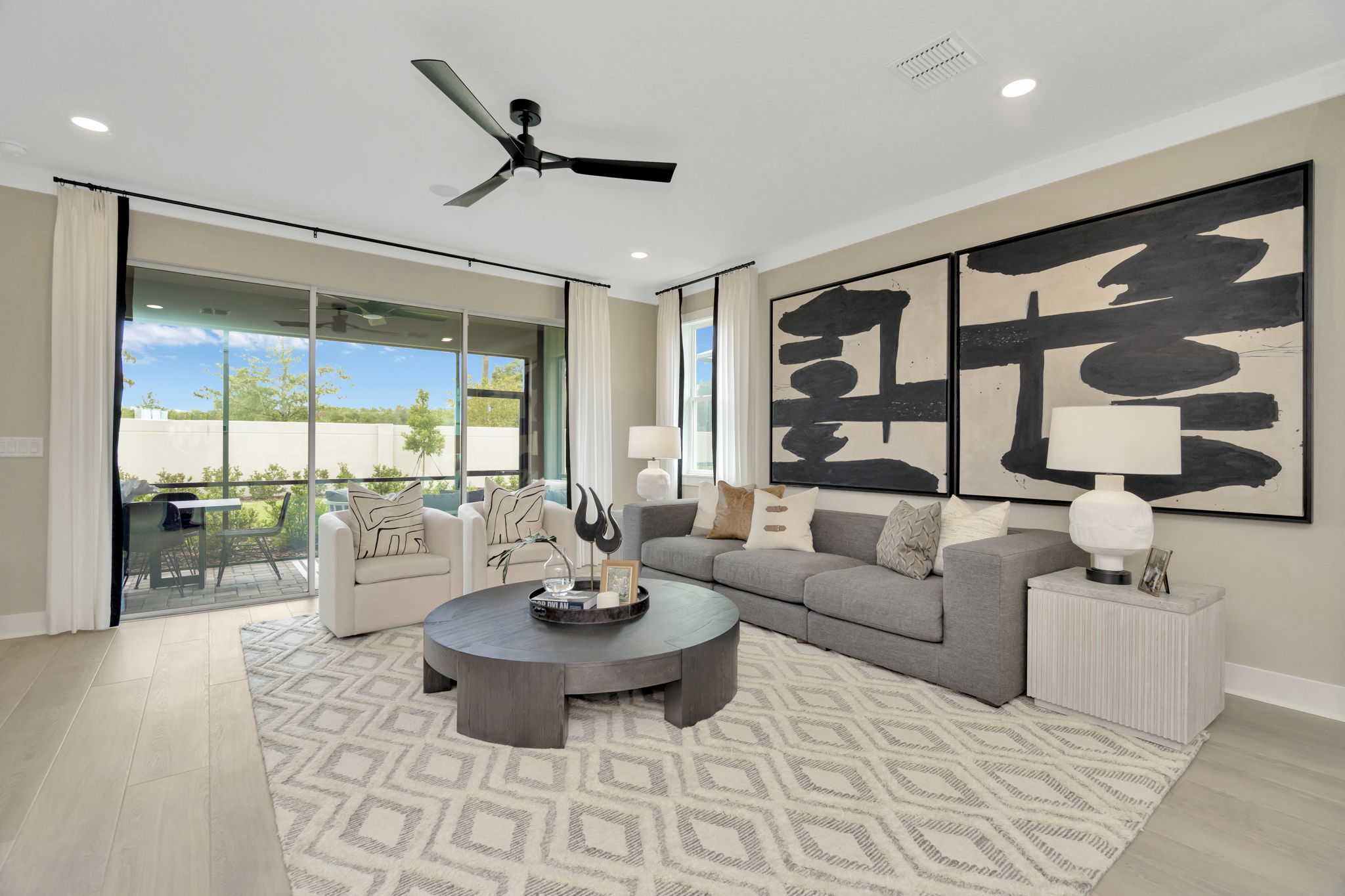 The Living Room of DRB Homes Cocoplum Home Plan at Primrose at Longleaf in New Port Richey, FL.