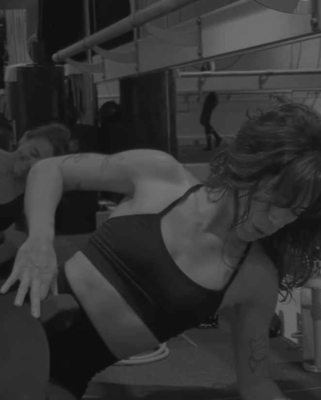 ure Barre Aventura member performing core strengthening exercises during a barre class in Aventura, FL