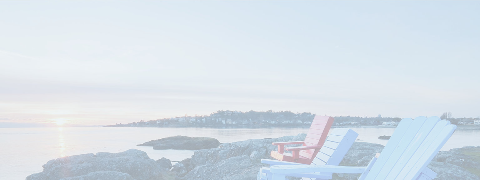 Colourful Muskoka chairs overlooking the water.