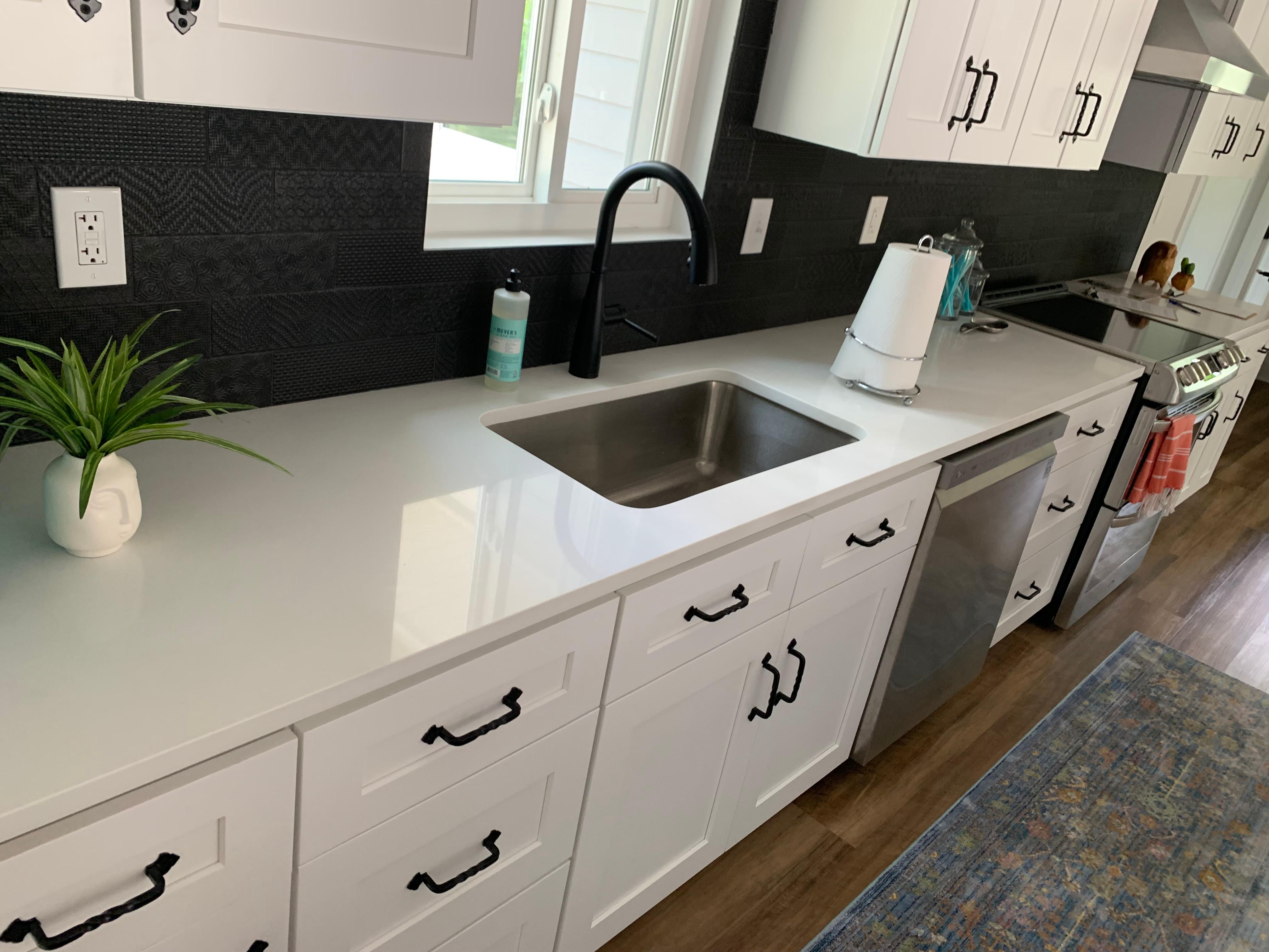 Updated white countertops and white cabinets.