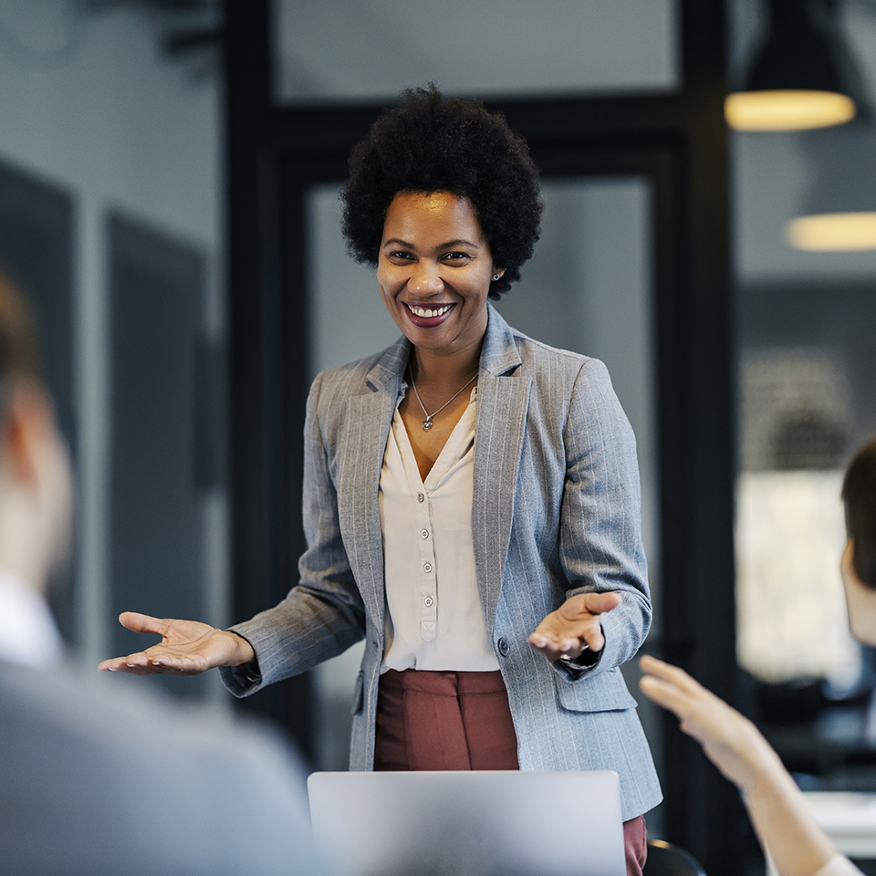 A woman in professional attire in an office.