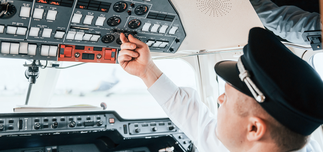 A pilot preparing for takeoff in the cockpit.