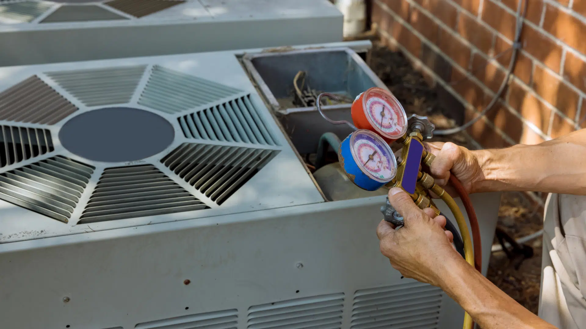 Certified HVAC technician performing refrigerant pressure diagnostics on a residential outdoor air conditioning unit. Professional AC maintenance and repair services help ensure optimal cooling performance, energy efficiency, and reliable home comfort during peak summer temperatures.