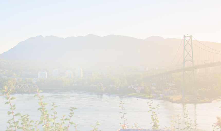 Suspension bridge in Vancouver with mountains in the background.