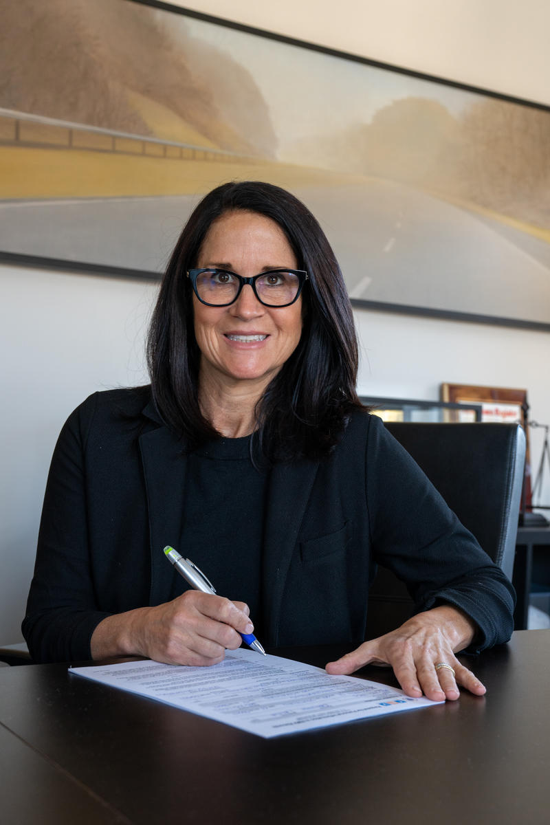 Attorney Kirsten Mendillo signing papers