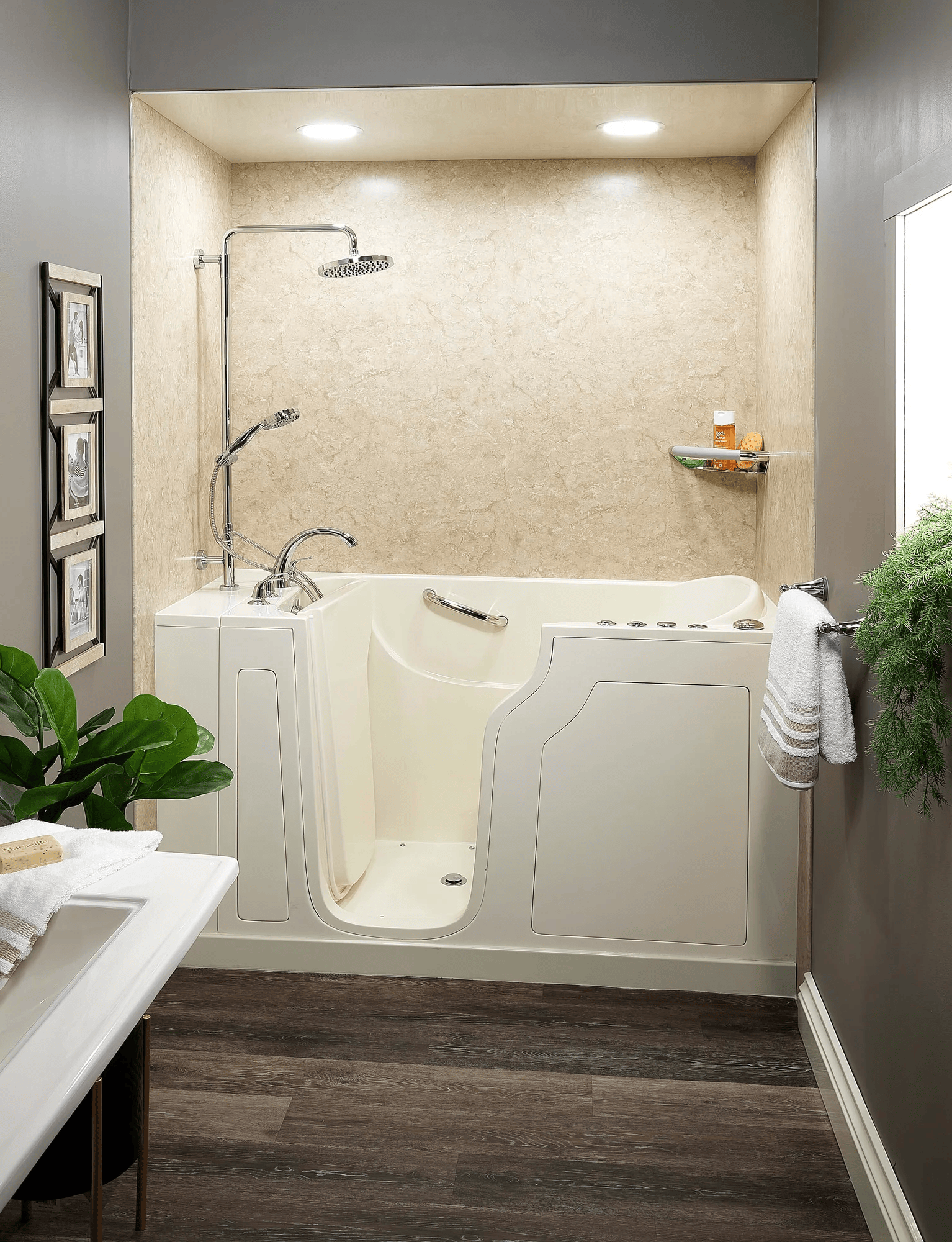 Bathroom featuring a Bath Concepts walk-in bathtub with easy-access door, built-in seating, and wall surround in a compact, modern space
