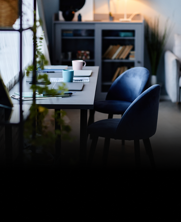 A home office desk with covered with documents.