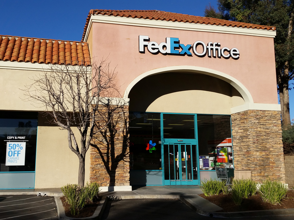Exterior photo of FedEx Office location at 24125 Magic Mountain Pkwy\t Print quickly and easily in the self-service area at the FedEx Office location 24125 Magic Mountain Pkwy from email, USB, or the cloud\t FedEx Office Print & Go near 24125 Magic Mountain Pkwy\t Shipping boxes and packing services available at FedEx Office 24125 Magic Mountain Pkwy\t Get banners, signs, posters and prints at FedEx Office 24125 Magic Mountain Pkwy\t Full service printing and packing at FedEx Office 24125 Magic Mountain Pkwy\t Drop off FedEx packages near 24125 Magic Mountain Pkwy\t FedEx shipping near 24125 Magic Mountain Pkwy