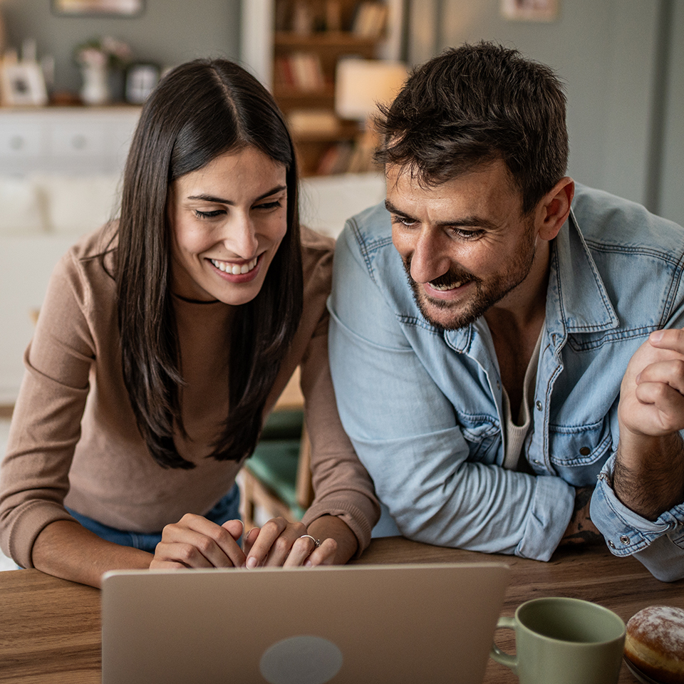 Two people looking at a laptop