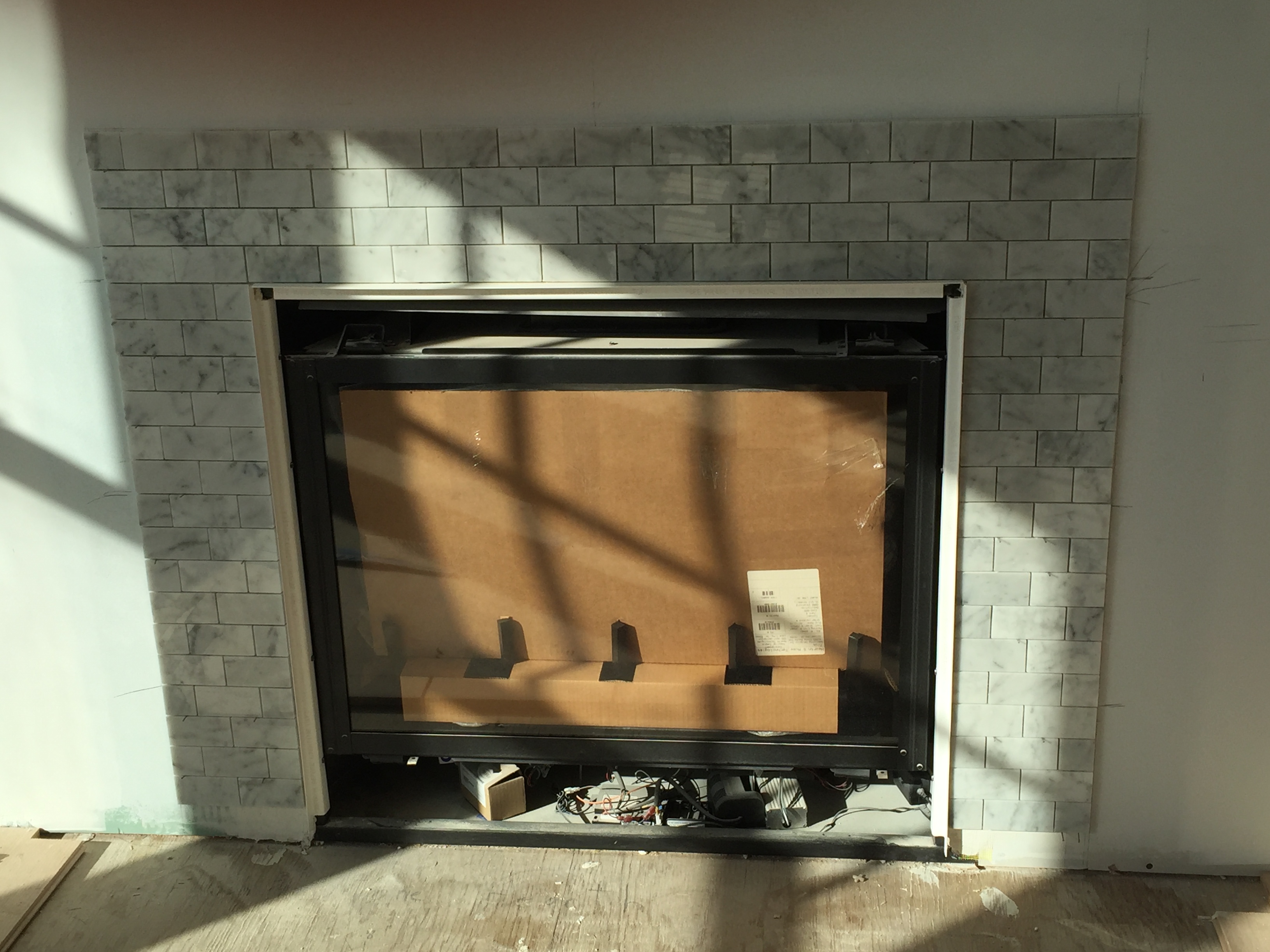 Normandy Beach Bay Project - tile installed around the gas fireplace