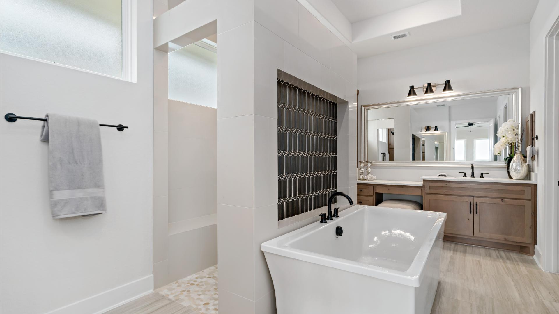 Lavish primary bathroom with walk-through shower and free-standing tub
