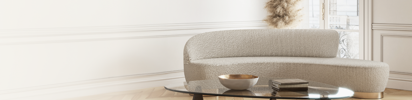 A modern, curved white couch in a stylish sitting room.