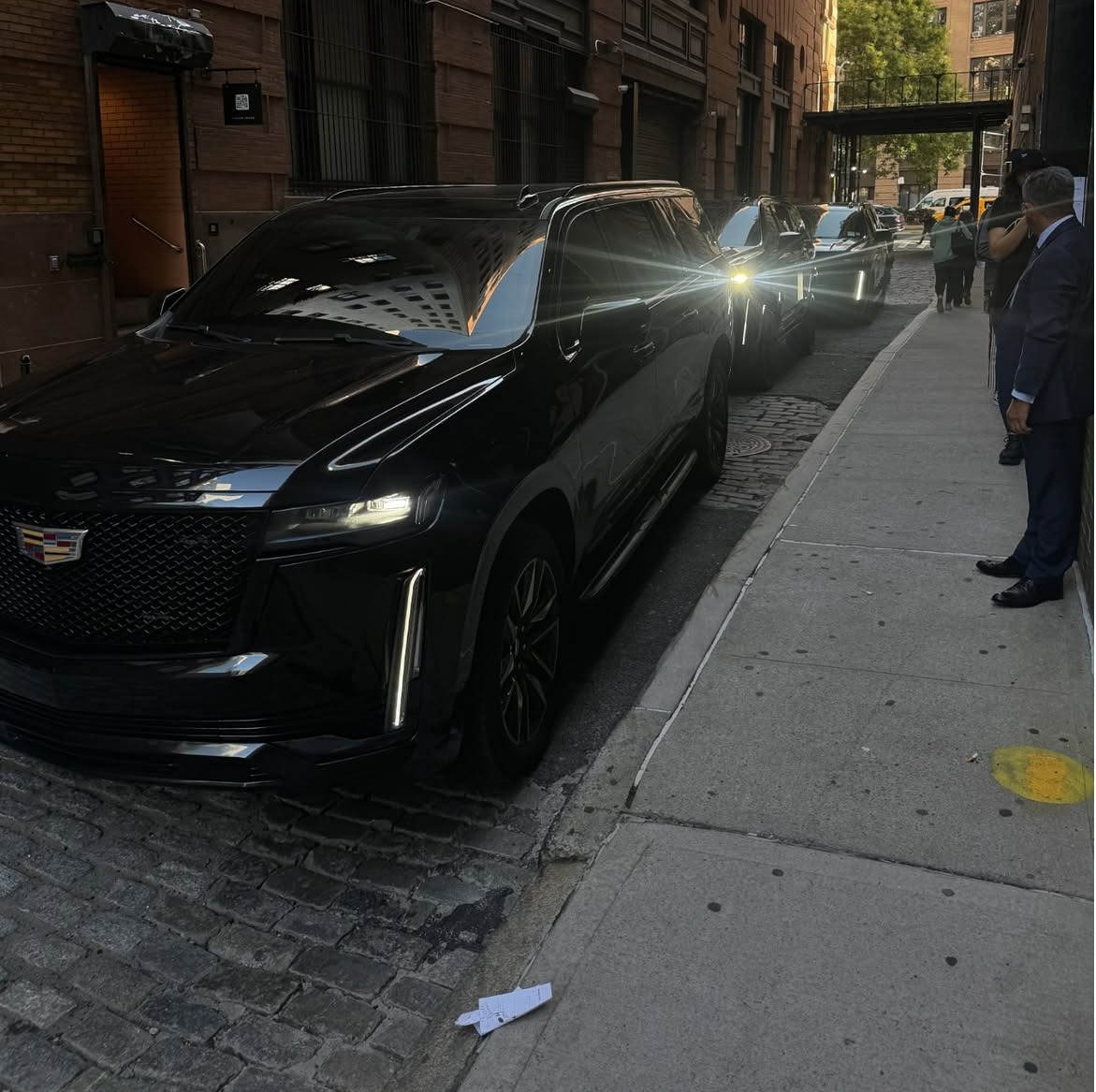 A line of Stealth Protection’s black luxury SUVs stands outside in a clean, commanding formation, creating an immediate impression of professionalism, readiness, and control. Each vehicle reflects the brand’s discreet, high-end image, with a polished presence that communicates reliability, executive-level service, and quiet confidence. Whether arriving for airport transportation, corporate travel, private client service, or coordinated protection assignments, the lineup represents Stealth Protection’s commitment to precision, consistency, and premium service from the very first impression.