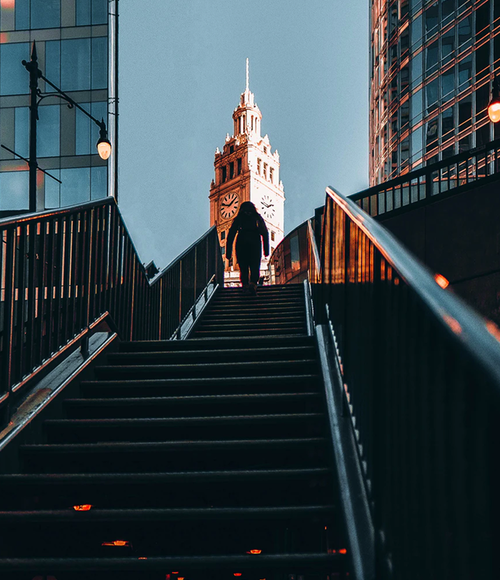 A long staircase leading towards a clock tower.