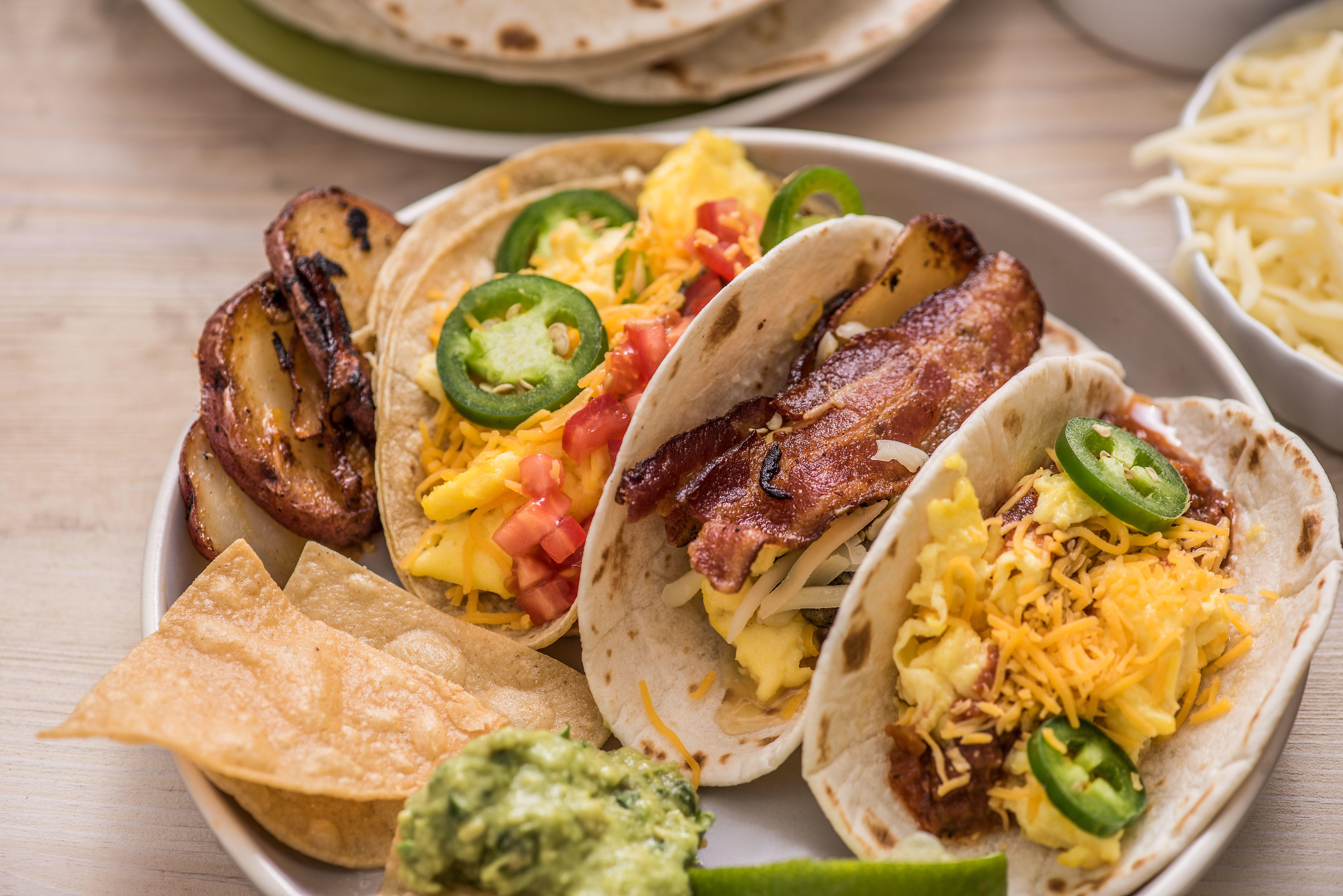 Breakfast tacos with bacon, eggs, jalapenos, jack and cheddar cheese Burrito Beach Chicago (773)462-0190