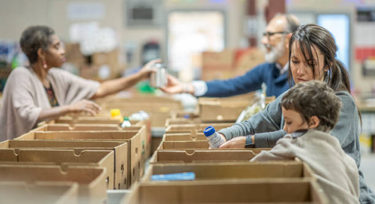 Individuals volunteering at a food bank.