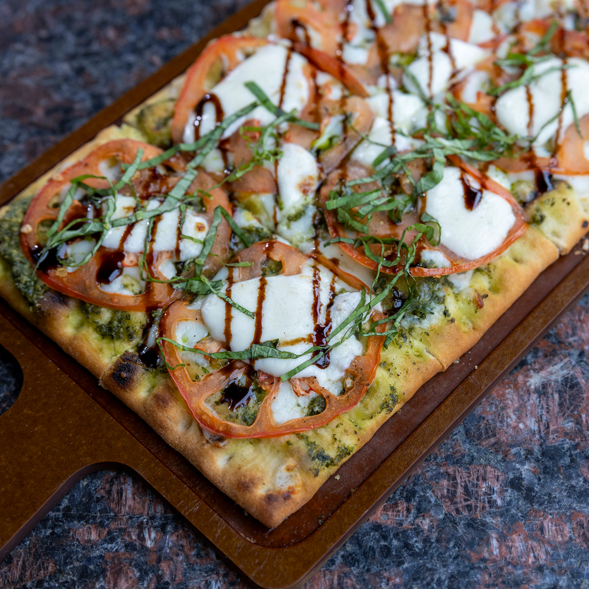 Margherita Flatbread | pesto, tomato, mozzarella, balsamic glaze & fresh basil