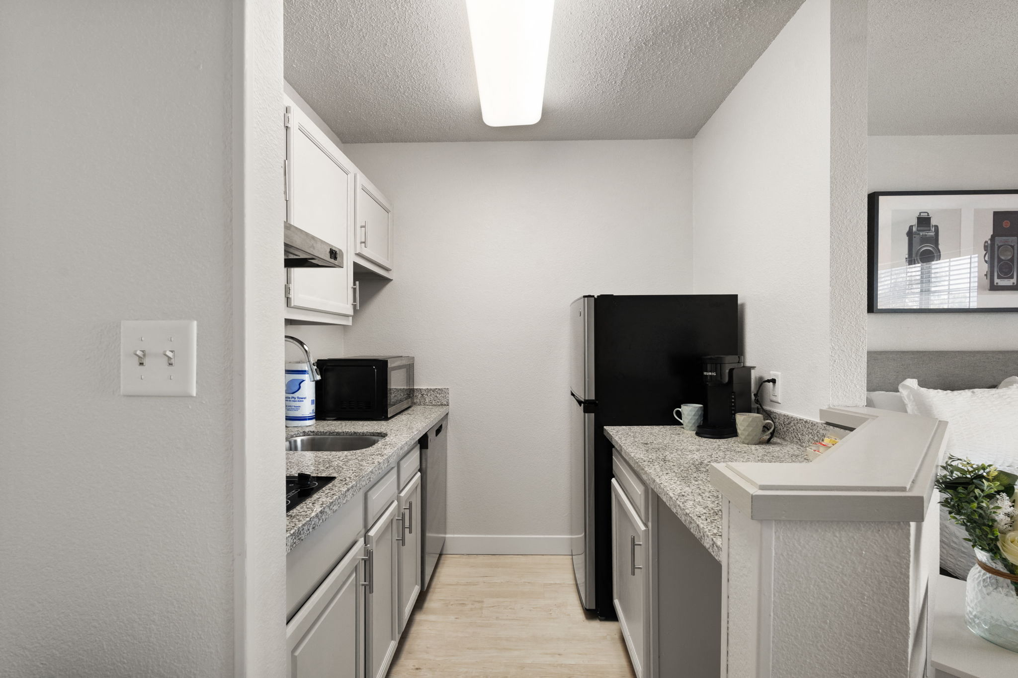 A kitchen with stainless steel appliances and granite counter tops at AVIA North Shore in Jeffersonville, IN