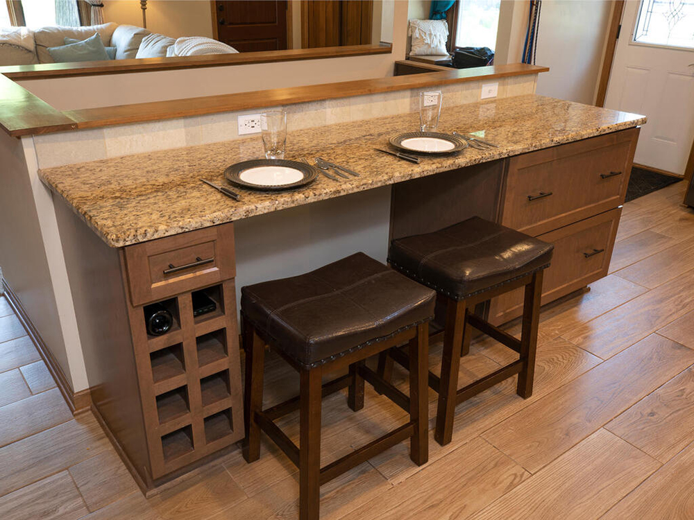 ZimmTown Construction’s kitchen remodel features a stylish breakfast bar, perfect for casual dining and entertaining. With sleek countertops, custom cabinetry, and modern lighting, the space blends function and elegance, creating a warm, inviting atmosphere.