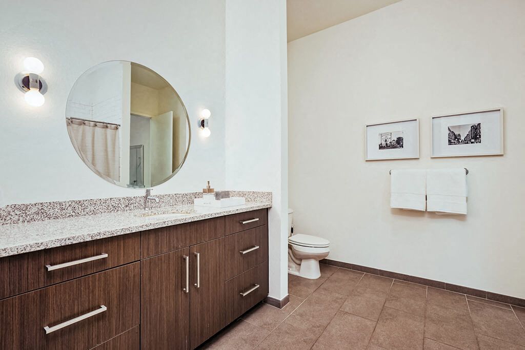 Spacious bathroom with dual vanity and framed artwork