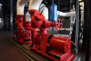 BC Ten Air HVACR and Electrical Contractors client mechanical room with red pump and piping assembly