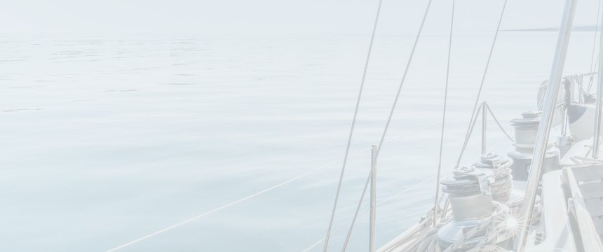 A sailboat on a calm body of water.