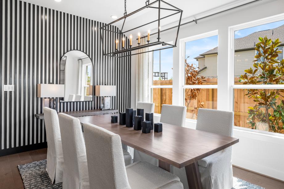 Dining space with chandelier and feature wall