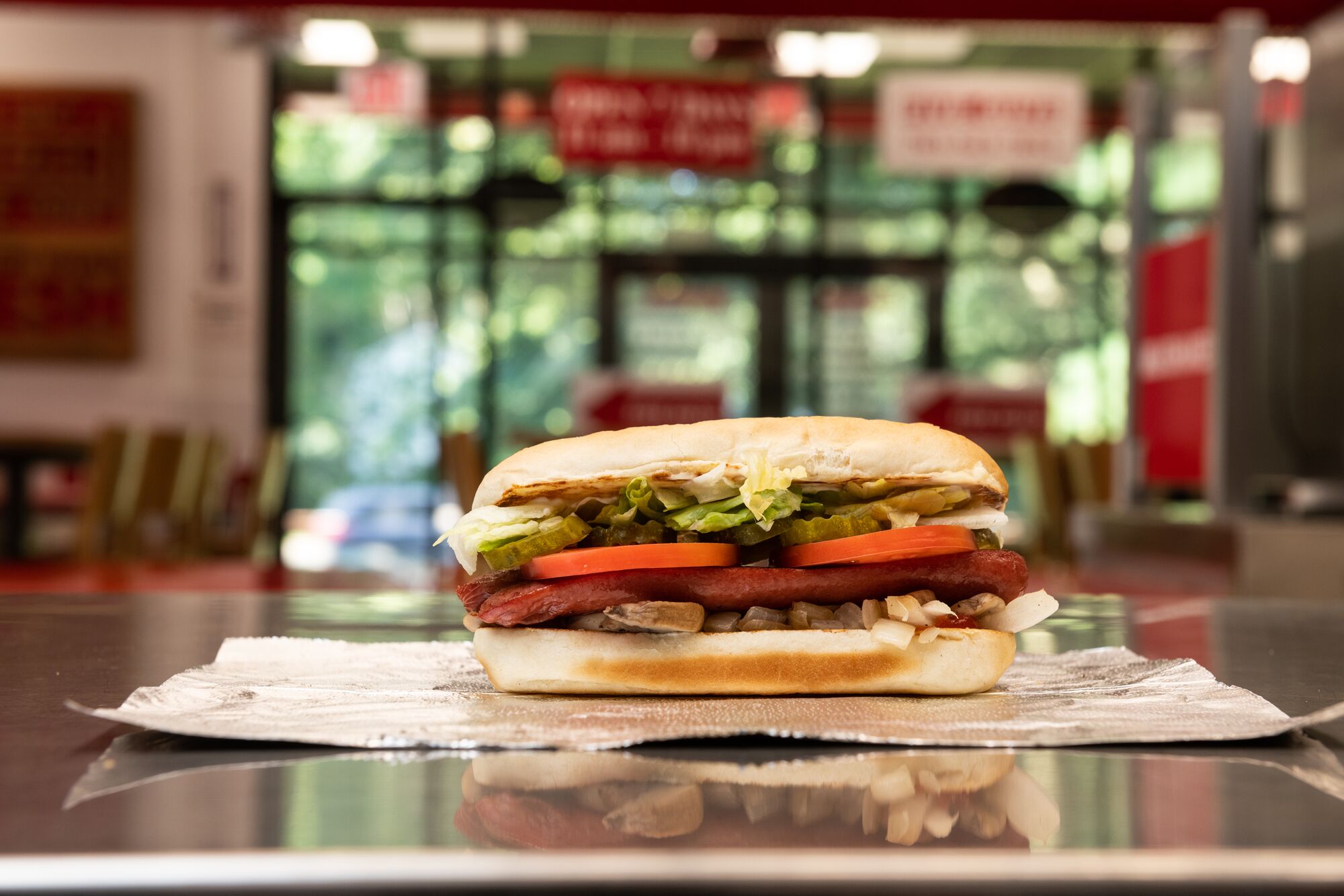 A Five Guys hot dog sits on the counter in a Five Guys restaurant. Five Guys Ottawa (613)562-8119