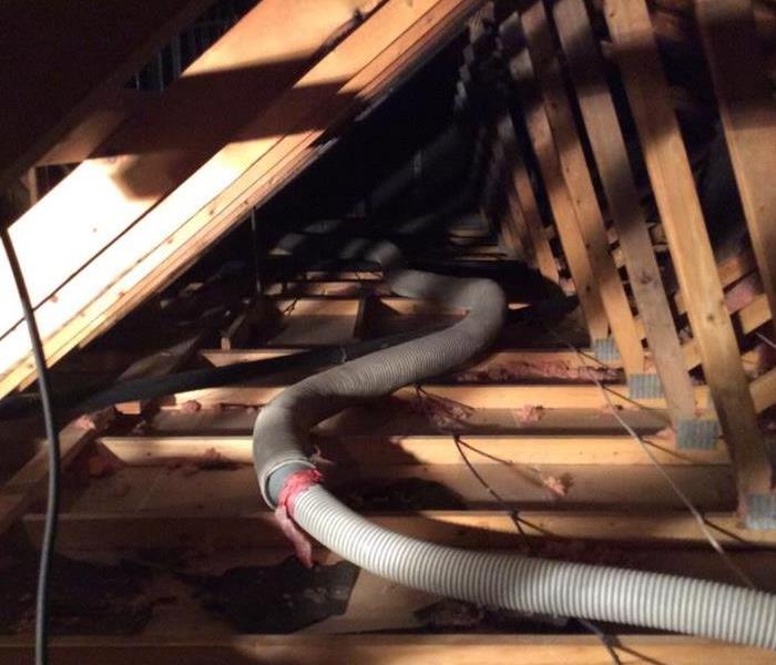 This attic was damaged due to a fire. Our dedicated team of Fire Restoration Technicians assessed the damage and began removing the affected insulation.