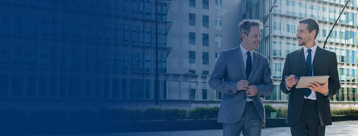 Two business professionals walking in the downtown core.