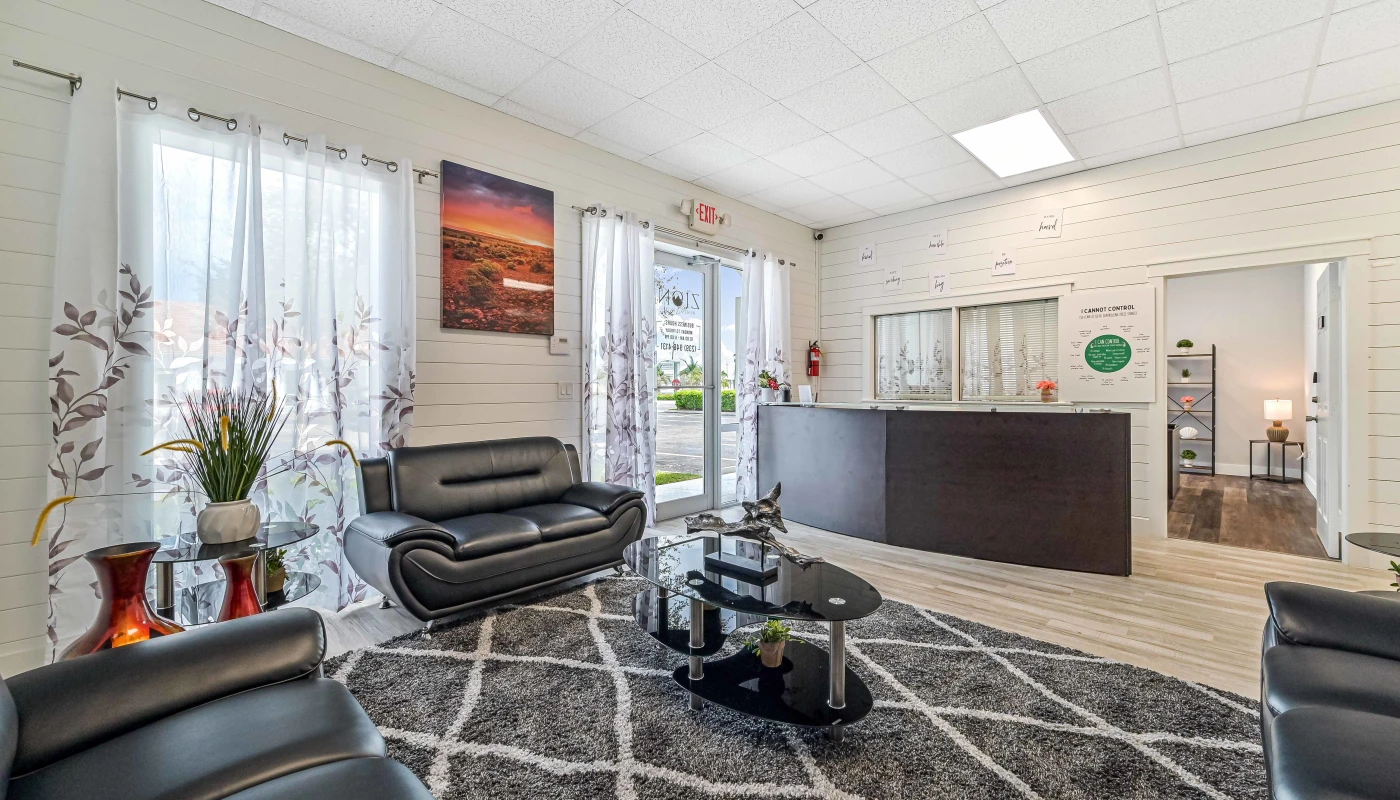 The reception area at Sprout Recovery in Fort Myers, FL offers a warm, home-like first impression for clients beginning treatment. Comfortable seating and calming decor help ease the intake experience.