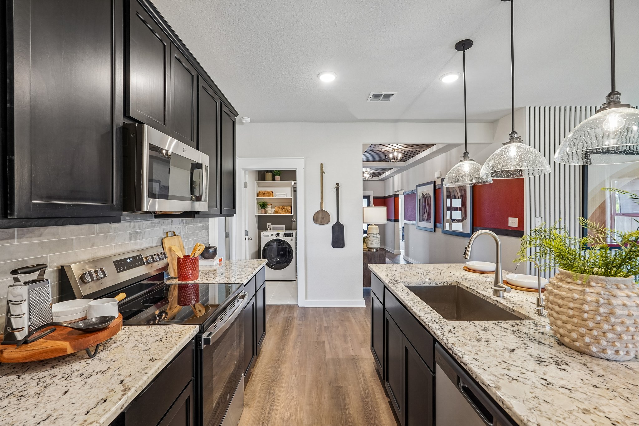 Modern Kitchen in New Braunfels with Dark Cabinets, Center Island & Designer Pendant Lighting at Clo 