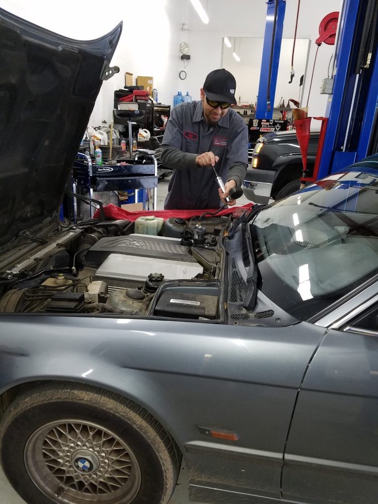 Hugo performing coolant pressure check on a classic BMW, safety first!
